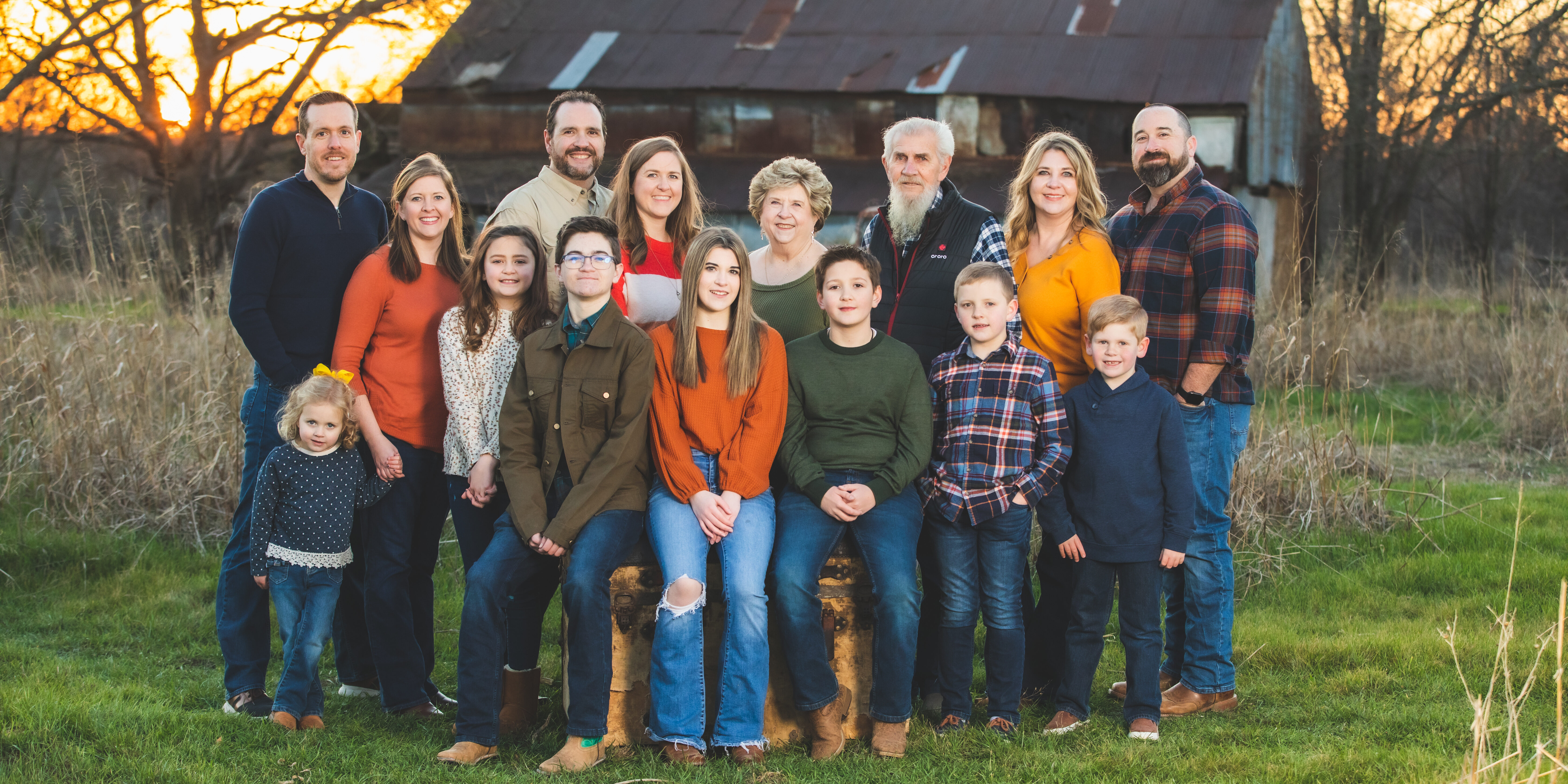 Large family sitting around a trunk