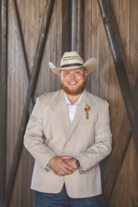 Groom in front of double doors