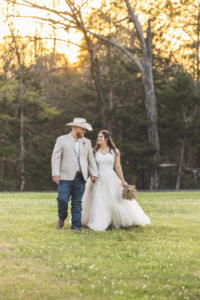 Bride and Groom walking in a field