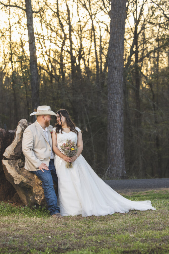 Bride & Groom leaning on a tree