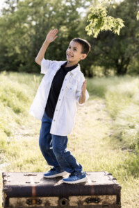 Boy standing on a trunk