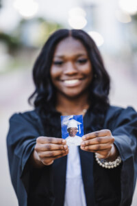 Girl holding a picture of herself when she was younger