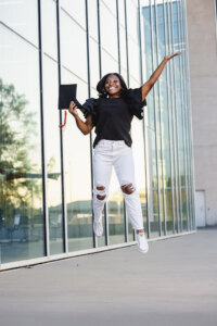 Girl in a Graduation cap jumping