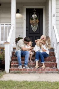 Family sitting on front porch
