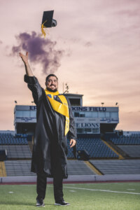 Man in cap and gown throwing his cap