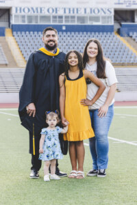 Man in cap and gown with his family