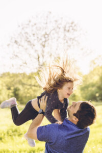 Dad throwing his daughter in the air